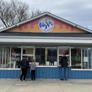 two people standing in front of a store