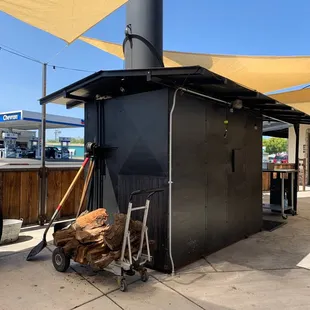 a bbq with a cart full of wood