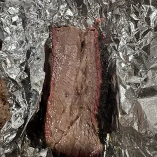 Beef brisket wrapped in foil for take out