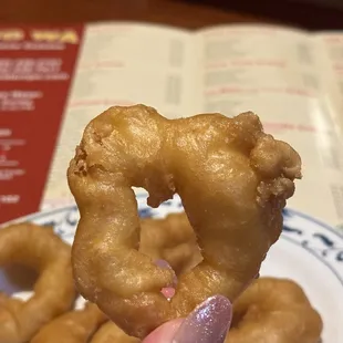 a hand holding a donut