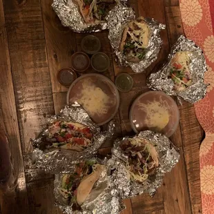 a variety of tacos on tinfoil