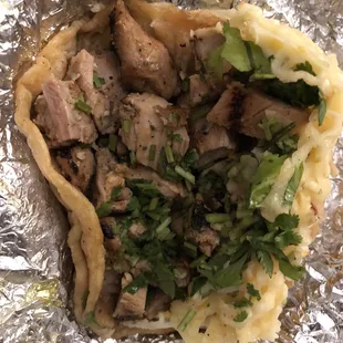 Chicken taco with cilantro and cheese. I got it to go and it was just as delicious the next day.