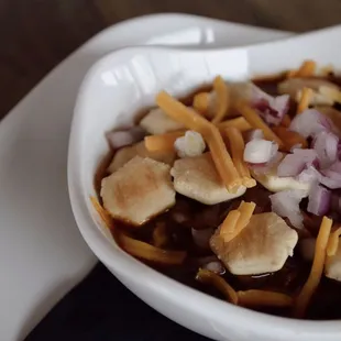 a bowl of chili and cheese