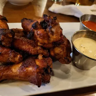 a plate of chicken wings and dipping sauce