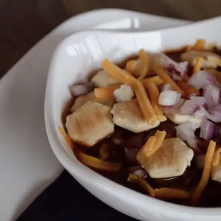 a bowl of chili and cheese