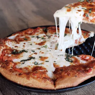 a slice of pizza being lifted by a spatula