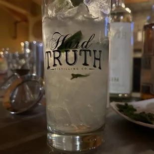 a glass of vodka with ice and mint