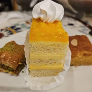 Mango cake, pistachio baklava, and coconut.