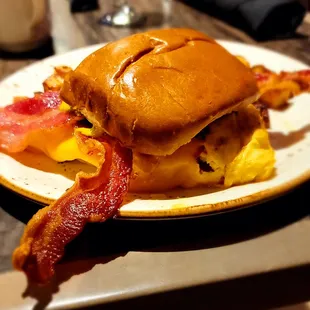 The Open Wide breakfast sandwich... Includes: brioche bun, cheesy eggs, roasted tomato, bacon &amp; herb spread