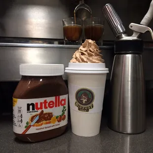 a cup of nutella next to a container of nutella