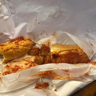 a half eaten sandwich and half eaten sandwich