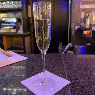 a glass of champagne on a table