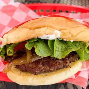 Hamburger with lettuce, tomato, pickle, grilled onion, and garlic herb mayo