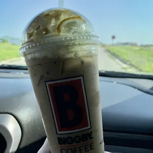 a hand holding a cup of coffee