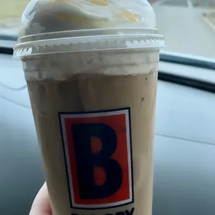 a hand holding a cup of coffee