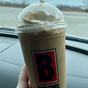 a hand holding a cup of coffee