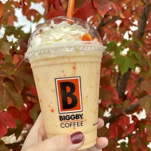 a hand holding a cup of coffee