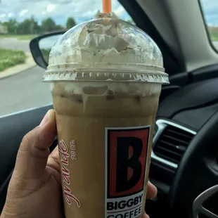 a hand holding a cup of coffee