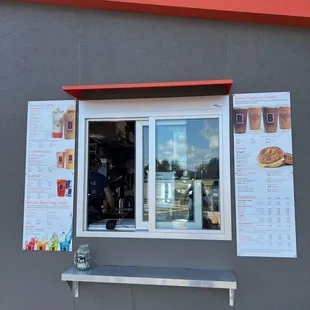 a man sitting in a window of a coffee shop