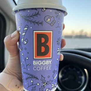 a hand holding a cup of coffee