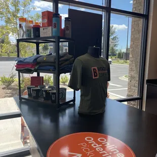 a t - shirt on a table in front of a window