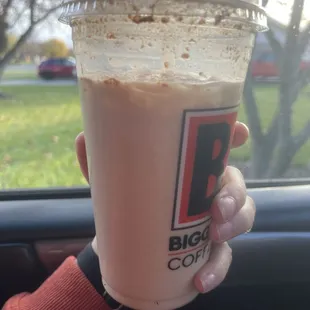 a hand holding a cup of coffee