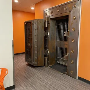an orange chair in front of a locked door