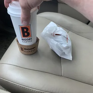 a hand holding a cup of coffee