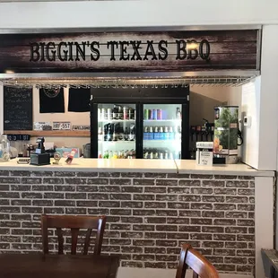 a brick wall with a sign that says biggin's texas bbq