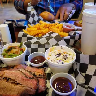 Brisket, green beans with bacon, coleslaw, bbq sauce, fries, pulled pork sandwich on pretzel bun, Texas toast