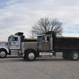 Biggs Backhoe and Trucking dump trucks. We use dump trucks to pull our backhoe trailers for storm shelter installations.