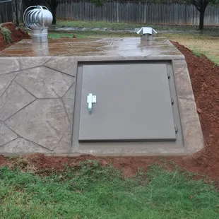 Newly Installed Brown Flagstone Below Ground Storm Shelter We Installed.