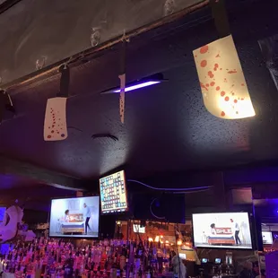 a bar with a lot of cards hanging from the ceiling