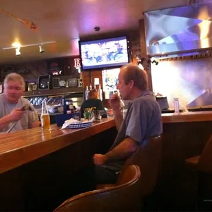 two men sitting at the bar