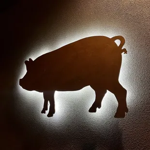 a silhouette of a pig