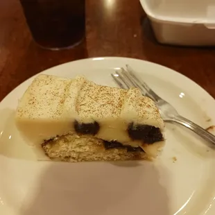 Cinnamon roll Cheesecake with a bite already out of it.