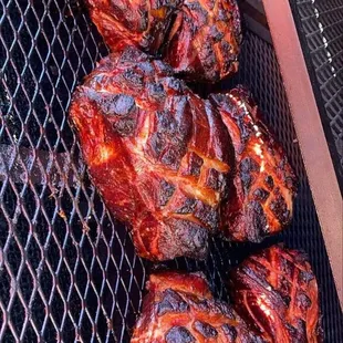 the meat being cooked on the grill