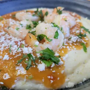 Creamy grits, Chili spice shrimp, salsa verda with cilantro on top!