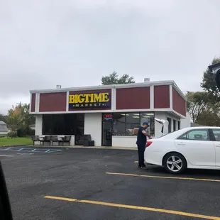 a man standing in front of a restaurant