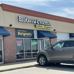 a car parked in front of a restaurant