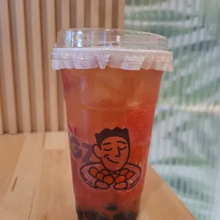 green tea with honey boba, strawberry puree, strawberry inclusion