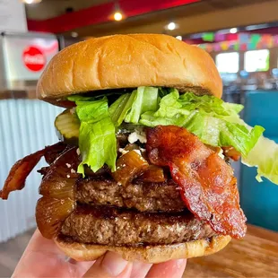 Double with bacon, blue cheese, beer-braised onions, and all the trimmings. Just look at how juicy those patties are!