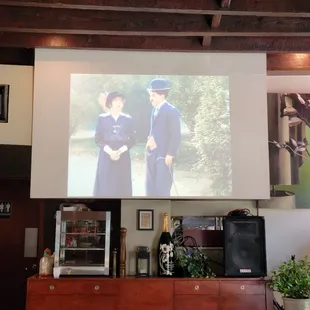 two women in uniform on a large screen