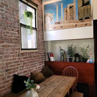 a dining room with a brick wall