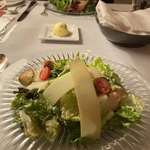 a glass plate with a salad on it