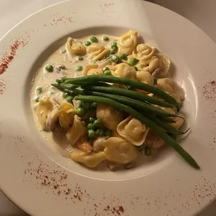 a plate of pasta and peas