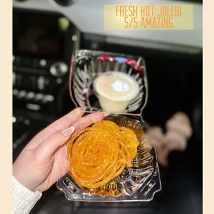 a person holding a tray of sweets