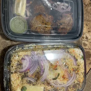 lamb chip on top, chicken biryani on bottom