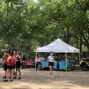 a group of people standing under a tent