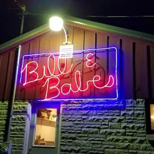 a neon sign in front of a building